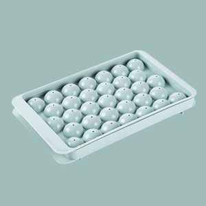 Detail showing the light blue spherical ice cube mold making multiple round ice balls