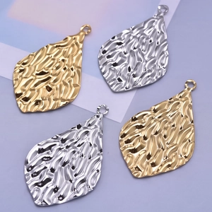 Detailed view of 304 stainless steel oval pendants with vintage hammered texture finish