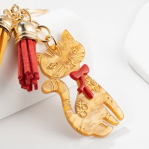 Amber cat keychain with red bow, golden ring and colorful suede tassels charm