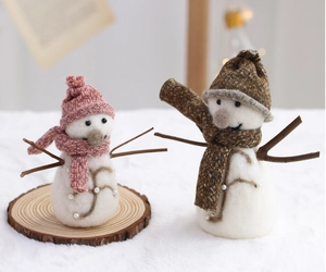 Detailed view of handmade wool felt snowmen with knit scarves for Christmas decor