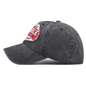 Side view of vintage charcoal grey washed cotton baseball cap with retro embroidered patches