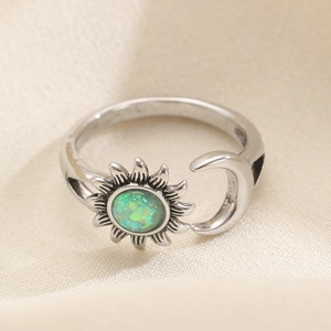 Close-up of adjustable sun and moon ring with green stone and retro silver finish