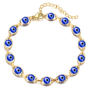 Detailed macro view of Evil Eye charm bracelet with blue beads and gold plating
