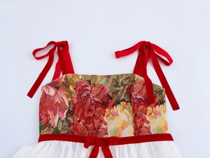 Dettaglio del corpetto jacquard floreale vintage con spalline e fiocco in velluto rosso