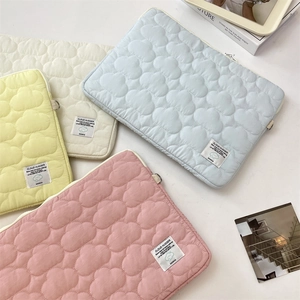 Quilted tablet sleeve collection with cloud patterns and Cloud Hugger logo labels