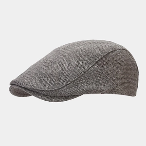 Detail of the gray knitted texture and side stitching on the casual flat cap hat