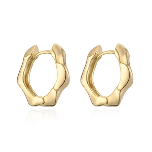 Detailed view of wavy hexagonal gold-plated hoop earrings with smooth reflective finish