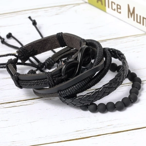 Detail of multi-layer black leather bracelets with infinity symbol and beaded rope