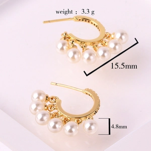 Detail shot of gold hoop earrings with pearl tassels and size specifications