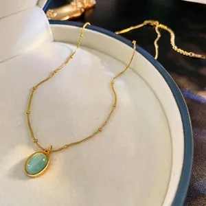 Luxury gold plated oval pale green gemstone necklace with delicate bead chain detail