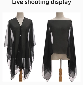 Detail of black chiffon shawl featuring pearl button closure and versatile styling options