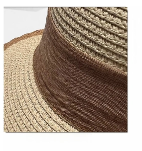 Close-up detail of the woven straw texture and premium brown ribbon on the wide brim sun hat
