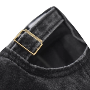 Macro view of adjustable bronze buckle and washed vintage denim fabric on the baseball cap