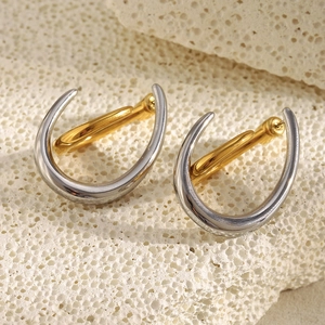 U-shaped two-tone 18K gold plated stainless steel earrings on a white coral stone