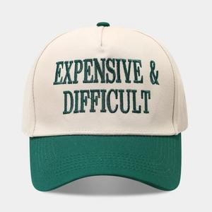 Close-up of vintage embroidered baseball cap with Expensive & Difficult text design