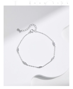 Detail of silver S925 bracelet with cubic zirconia and S925 hallmark on minimalist set
