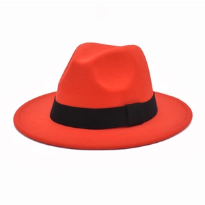 Detailed view of red wool fedora hat with classic black ribbon and wide brim design