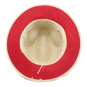 Detailed interior of straw Panama hat showing beige weave and red brim with chin strap