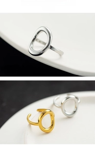 Detail of 18k gold and silver stainless steel rings with minimalist hollow oval design