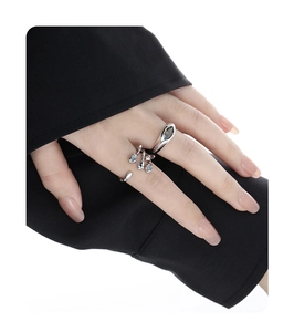 Detailed macro of silver leaf ring and green zircon stone on a woman's hand