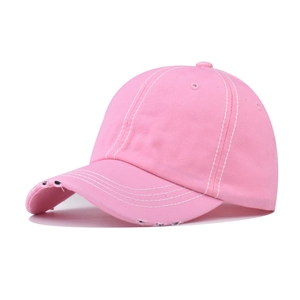 Detail of pink washed cotton baseball cap with distressed brim and white contrast stitching