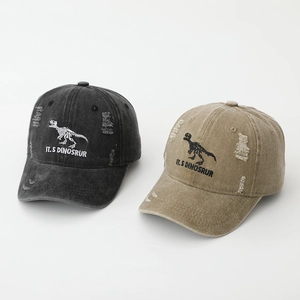 Detail of dinosaur skeleton embroidery on vintage washed cotton kids' baseball caps