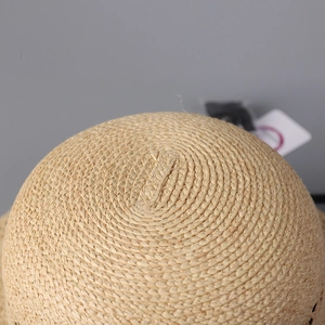 Macro shot of high-quality raffia dome hat showing natural woven texture and detail