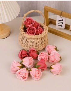 Macro detail of pink soap rose heads in a woven basket for Valentine's floral decor