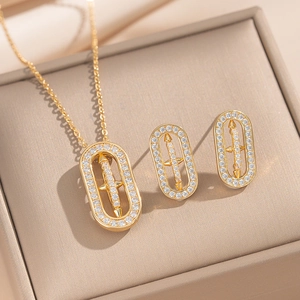 Elegant gold-tone oval necklace and earring set with cross pattern and clear zircon stones