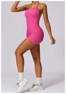 Detailed back view of pink ribbed yoga jumpsuit showing halter neck and slim fit silhouette