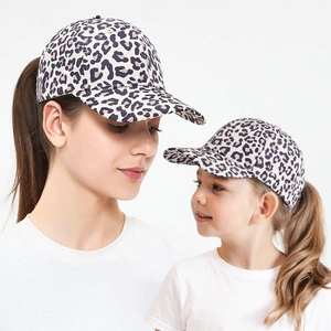 Close-up of matching leopard print ponytail baseball caps for mother and daughter