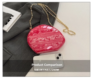 Pink marble acrylic clutch bag shown next to a smartphone for size comparison