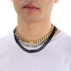 Three-color Cuban link necklaces in gold, silver, and black on a male model's neck