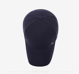 Top view of navy blue baseball cap with six-panel structure and metal logo detail