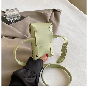 Close-up of light green PU leather crossbody bag featuring stylish metal rivet flap