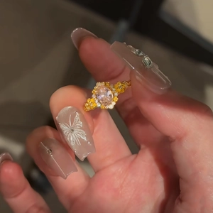 Detail of 24k gold plated vintage flower ring with pink teardrop stone and yellow gems