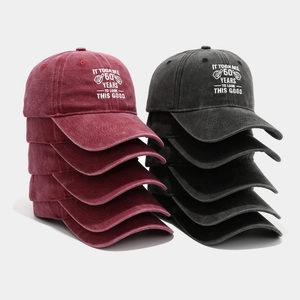 Close-up of embroidered vintage washed cotton baseball caps with 50th birthday quote