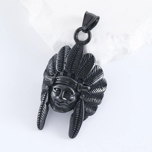 Detailed view of a black stainless steel Indian chief head pendant on a white rock