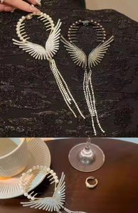 Detail of angel wing hair claw clip featuring shimmering rhinestones and long tassel chains