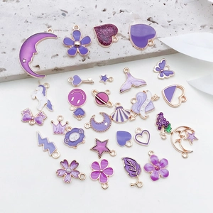 Detail of assorted purple enamel alloy pendants including stars, hearts and moon shapes