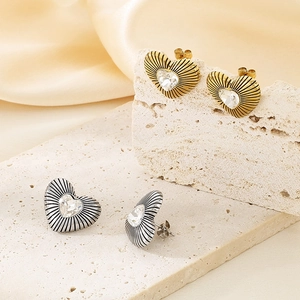 Square textured 18k gold heart earrings set with sparkling crystals on stone base
