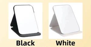 Detail showing black and white foldable desktop makeup mirrors with stand bases
