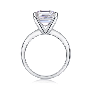Macro shot of rectangular princess cut moissanite set in silver toned four-claw ring