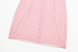 Detailed close-up of pink and white checkered fabric with fine stitching quality