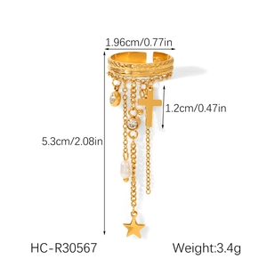 Detail of golden tassel ring with cross, star, pearl and zircon measuring 5.3cm