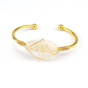 Detailed view of handmade gold wire-wrapped clear natural crystal stone open bangle