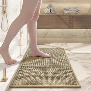 Close-up of rectangular chenille bath mat with dense pile texture on marble floor