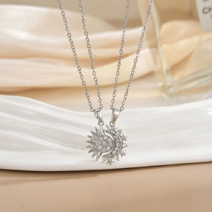 Detailed view of silver sun and moon necklaces set with micro-pave cubic zirconia stones