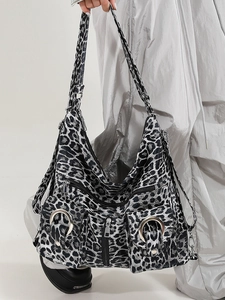 Fashionable black and white leopard print tote bag with multiple zip pockets and ring detail