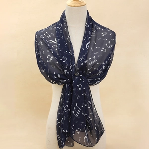 Detailed view of lightweight navy blue chiffon scarf featuring white musical note patterns